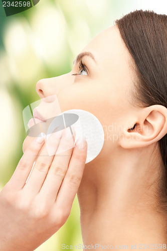 Image of beautiful woman with cotton pad