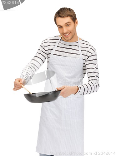 Image of handsome man with pan and spoon