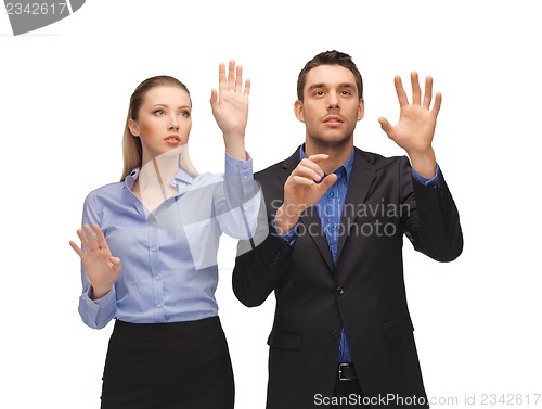 Image of man and woman working with something imaginary