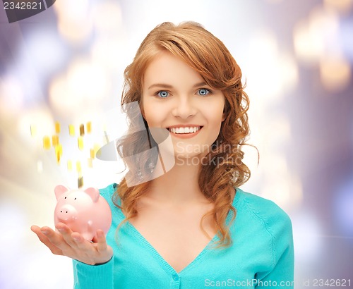 Image of teenage girl with piggy bank