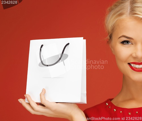 Image of lovely woman in red dress with shopping bag