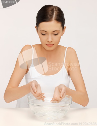 Image of woman washing her face