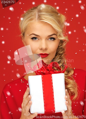 Image of lovely woman in red dress with present