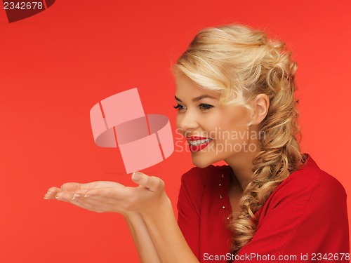Image of woman blowing something on the palms of her hands
