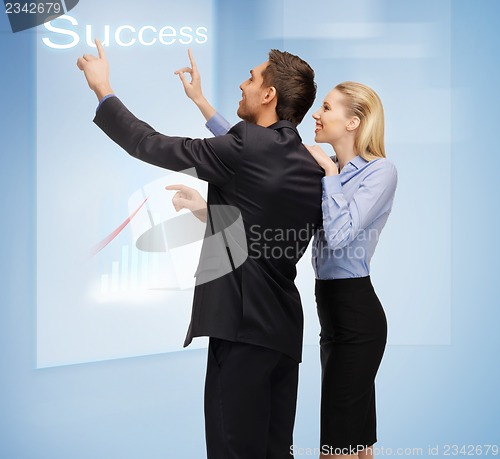 Image of man and woman working with virtual touch screens