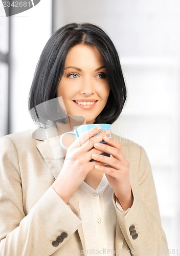 Image of lovely businesswoman with mug