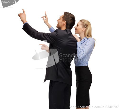 Image of man and woman working with something imaginary