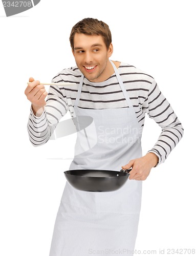Image of handsome man with pan and spoon