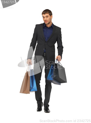 Image of handsome man in suit with shopping bags