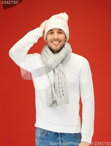 Image of handsome man in warm sweater, hat and scarf