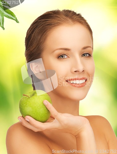 Image of young beautiful woman with green apple