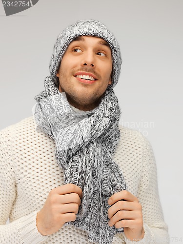 Image of handsome man in warm sweater, hat and scarf