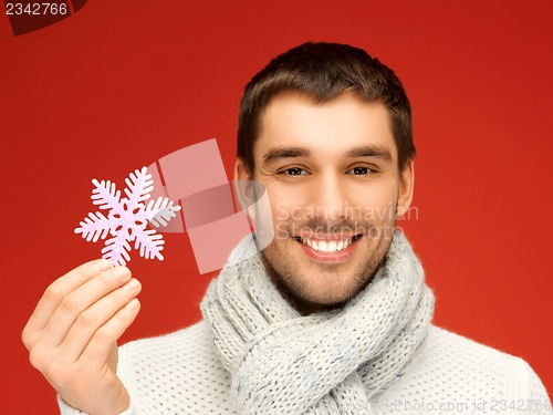 Image of man in warm sweater and scarf with snowflake