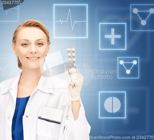 Image of attractive female doctor with pills