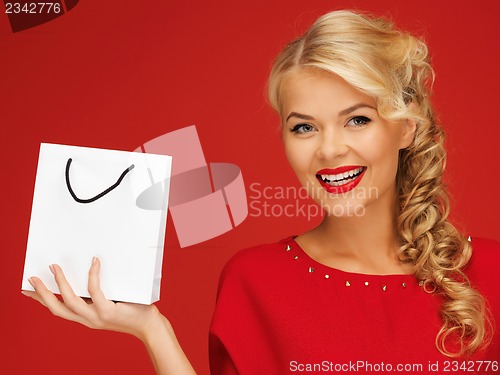 Image of lovely woman in red dress with shopping bag