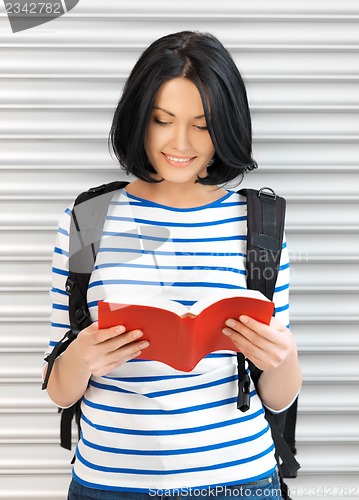 Image of woman with bag and book