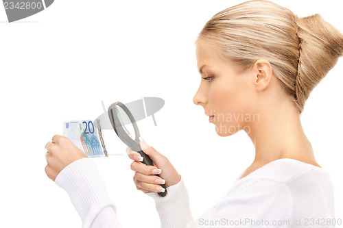 Image of woman with magnifying glass and euro cash money