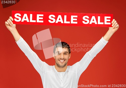 Image of handsome man with sale sign