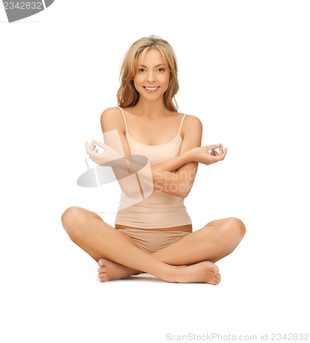 Image of woman practicing yoga lotus pose