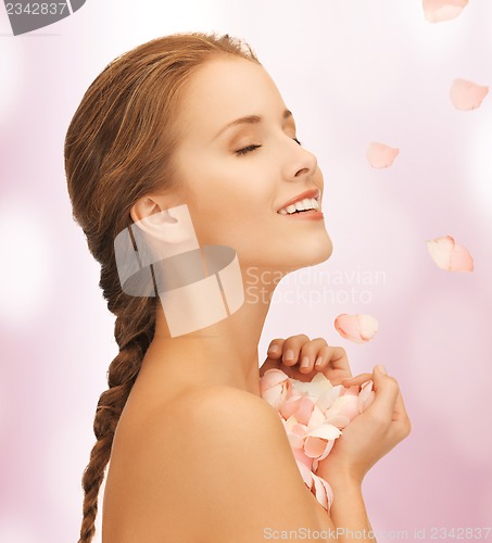 Image of beautiful woman with rose petals