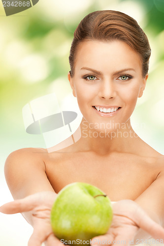 Image of young beautiful woman with green apple