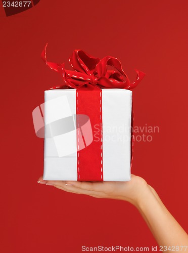 Image of woman's hands holding a gift box