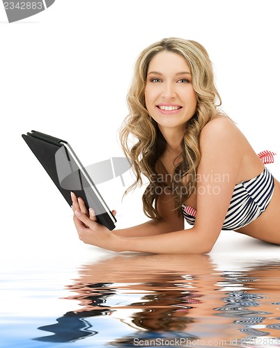 Image of woman in bikini with tablet pc computer