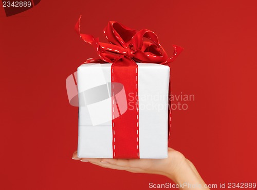 Image of woman's hands holding a gift box