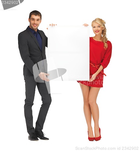 Image of couple holding big blank board