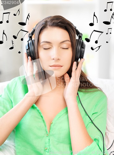 Image of happy teenage girl in big headphones