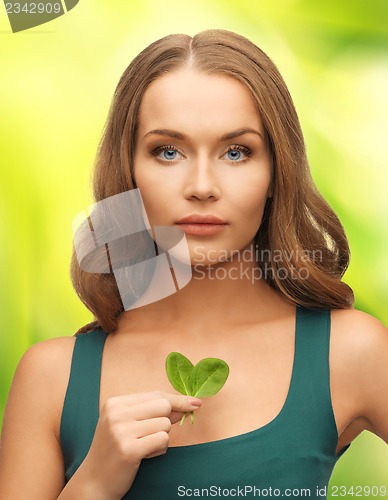 Image of woman with spinach leaves