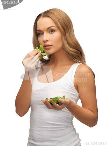 Image of woman with spinach leaves on palms