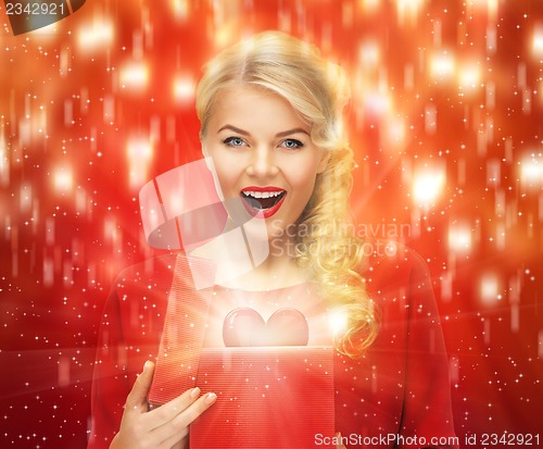 Image of lovely woman in red dress with valentine gift box