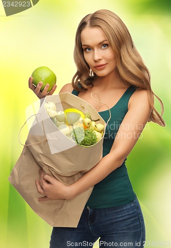 Image of woman with shopping bag full of fruits