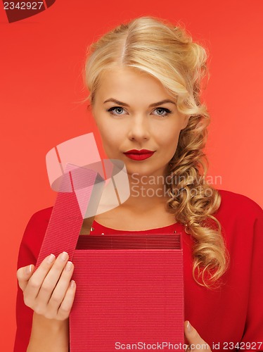 Image of lovely woman in red dress with opened gift box