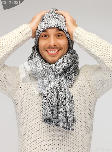 Image of handsome man in warm sweater, hat and scarf