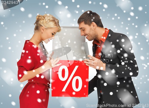 Image of man and woman with percent sign