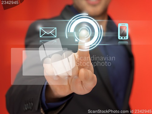Image of handsome man in suit pressing virtual button
