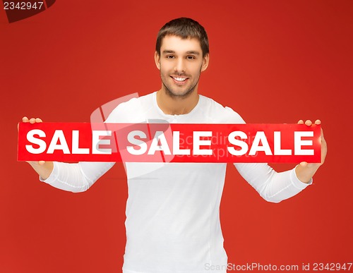 Image of handsome man with sale sign