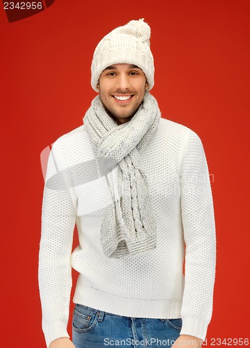 Image of handsome man in warm sweater, hat and scarf