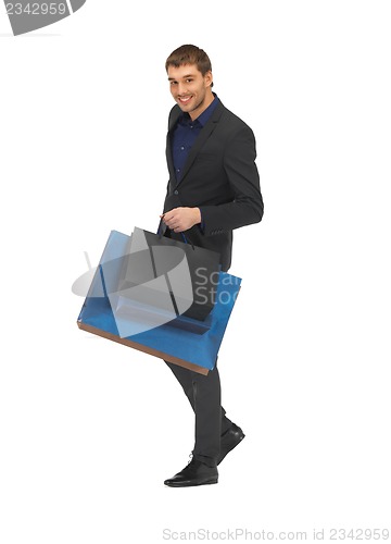 Image of handsome man in suit with shopping bags