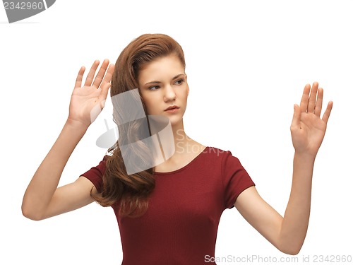 Image of teenage girl working with something imaginary