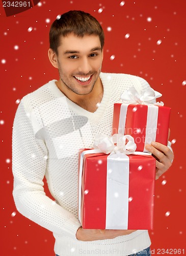 Image of man holding many gift boxes