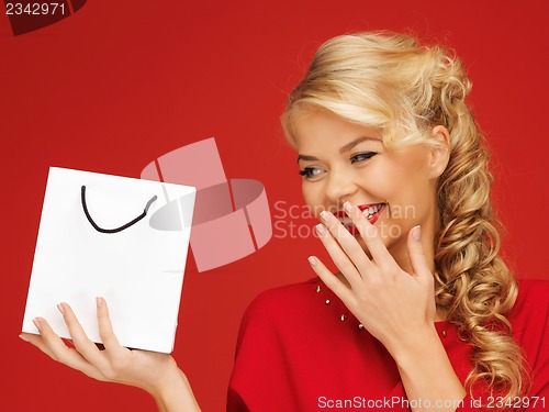 Image of lovely woman in red dress with shopping bag