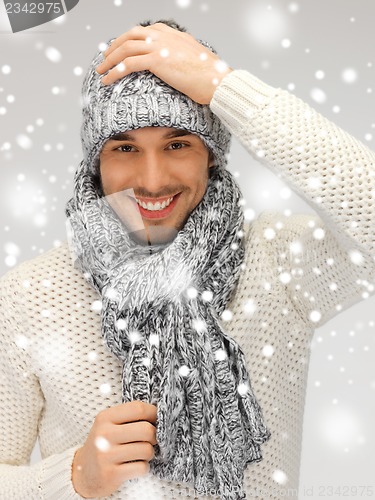 Image of handsome man in warm sweater, hat and scarf