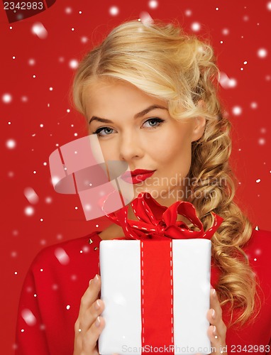 Image of lovely woman in red dress with present