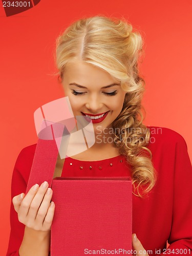 Image of lovely woman in red dress with opened gift box