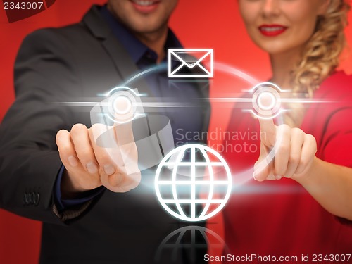 Image of man and woman pressing virtual button