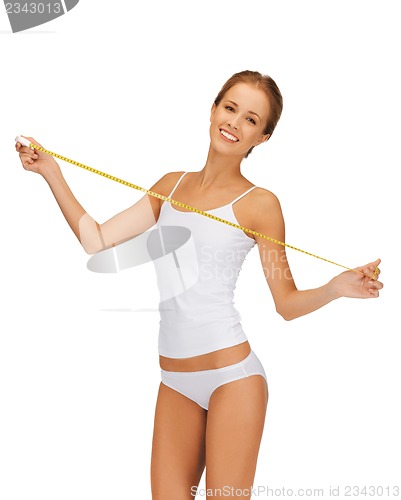 Image of young beautiful woman with measure tape