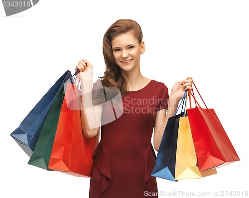 Image of teenage girl in red dress with shopping bags